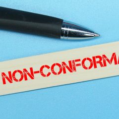 pen, a stick of colored ice cream with the word non-conformance